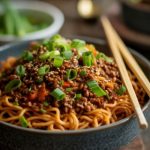 Bowl of lo mein noodles with ground beef sauce mixture.